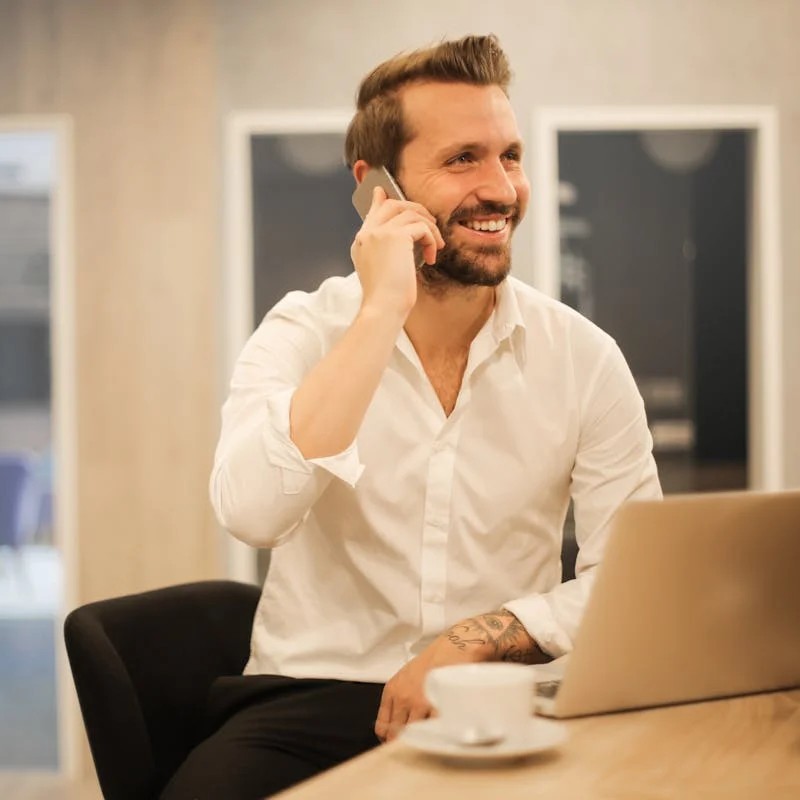 Advisors on the phone in front of laptop.